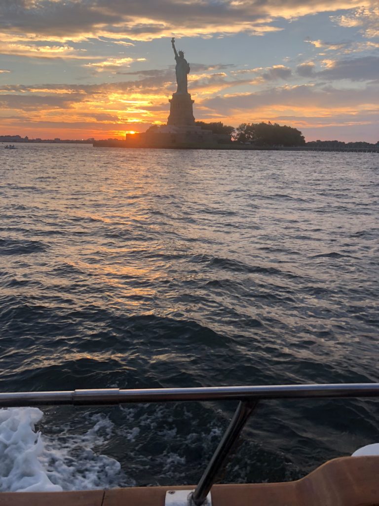 Statue of Liberty from boat at sunset